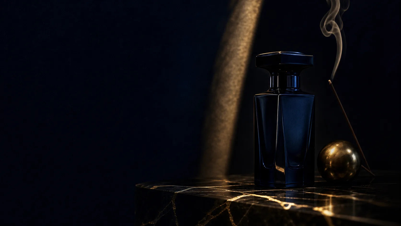 Fragrance bottle surrounded by botanical ingredients in warm light